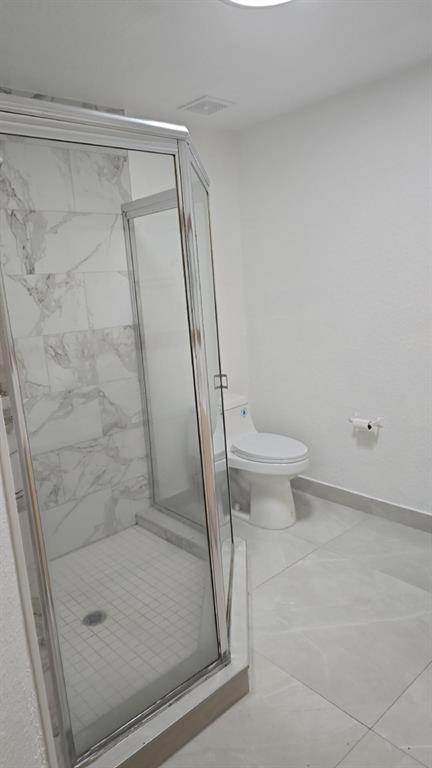 2801 Riverside Drive, Unit 104 Coral Springs, FL 33065 - Photo 13 of 22 a bathroom with a shower and a toilet