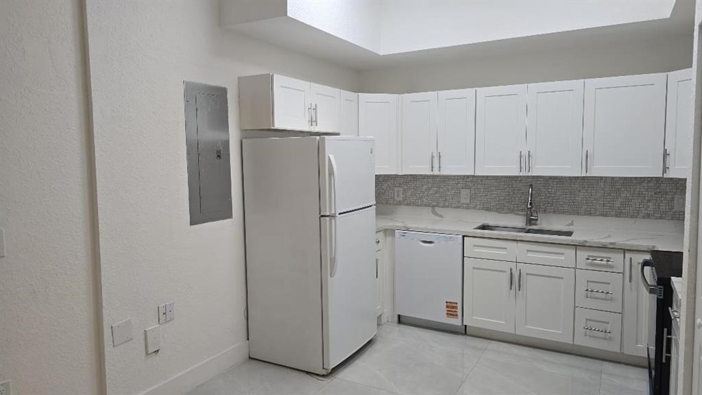2801 Riverside Drive, Unit 104 Coral Springs, FL 33065 - Photo 2 of 22 a kitchen with appliances a sink and cabinets