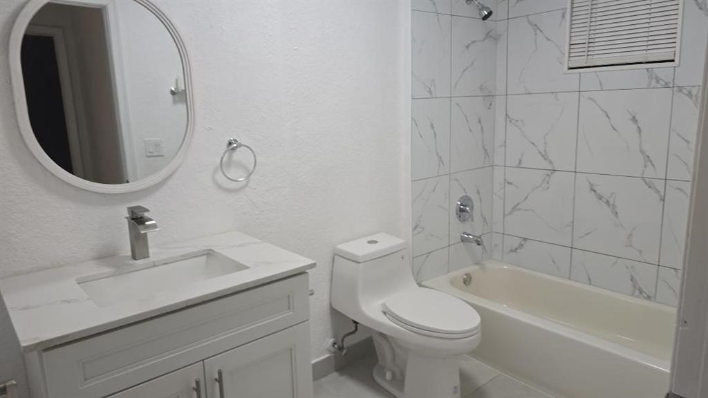 2801 Riverside Drive, Unit 104 Coral Springs, FL 33065 - Photo 22 of 22 a bathroom with a sink a toilet and bathtub