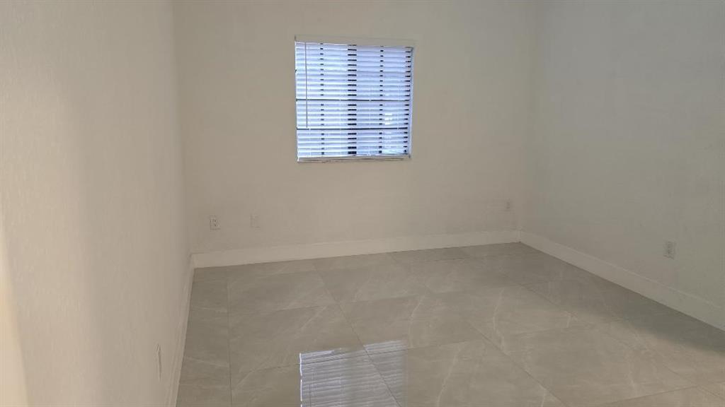 2801 Riverside Drive, Unit 104 Coral Springs, FL 33065 - Photo 8 of 22 a view of an empty room with a window