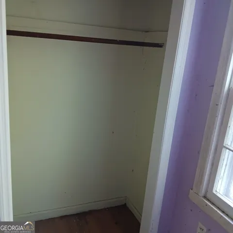 a bed sitting in a bedroom next to a window