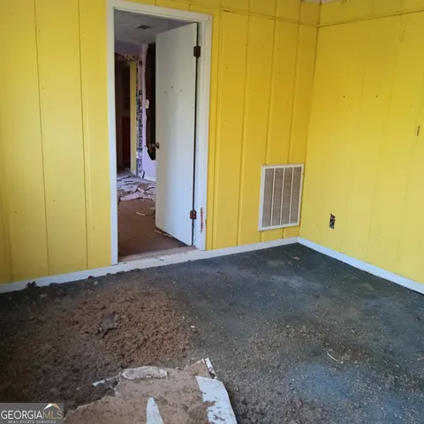 a view of an empty room with windows