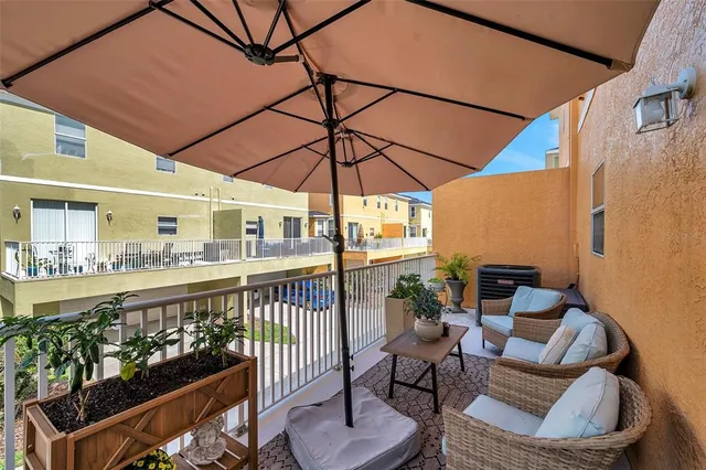 a view of a chairs and table in the balcony