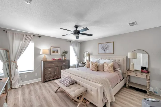 a bedroom with a bed and a dresser with mirror