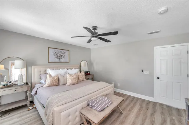a bedroom with a bed and a chandelier