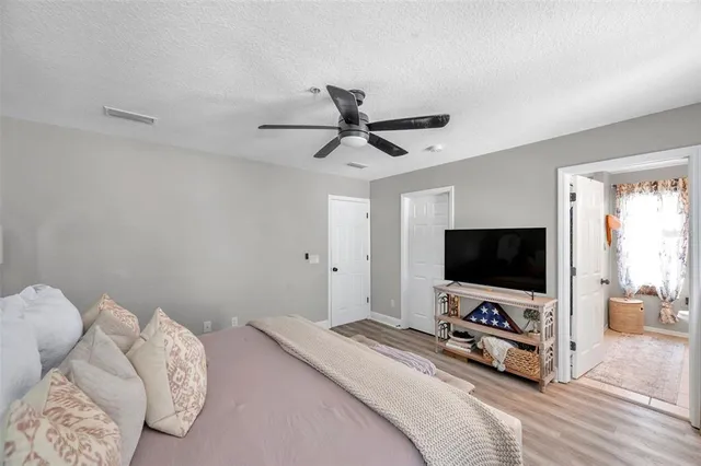 a bedroom with bed tv and window