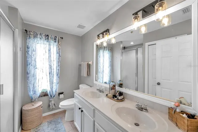 a bathroom with double sink and a mirror