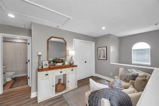 a bedroom with furniture and a wooden floor