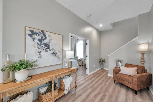 a living room with furniture and flowers