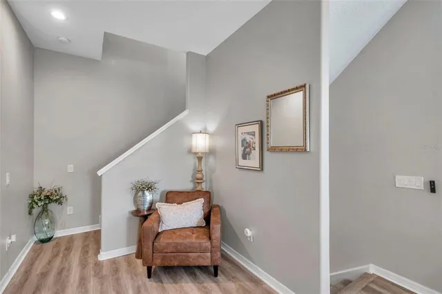 a hallway with furniture and wooden floor