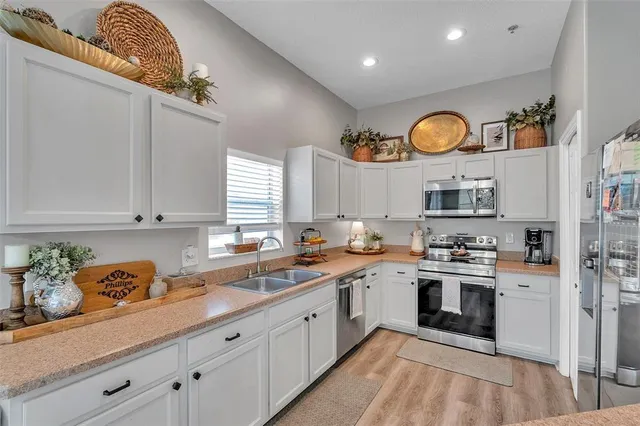 a kitchen with cabinets and window