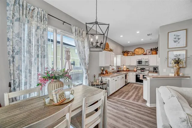 a kitchen with counter top space and wooden floor
