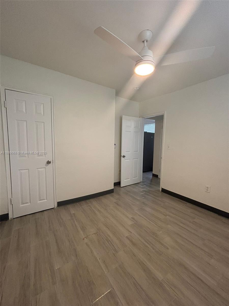 708 Northwest 4th Avenue, Unit 4 Miami, FL 33136 - Photo 12 of 17 a view of an empty room with wooden floor