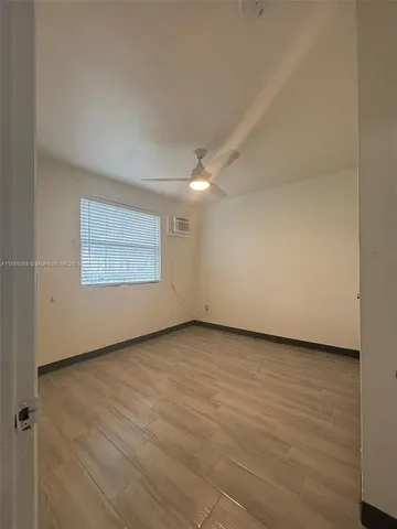 an empty room with a empty space and wooden floor