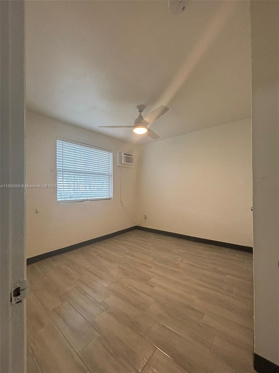 708 Northwest 4th Avenue, Unit 4 Miami, FL 33136 - Photo 15 of 17 an empty room with a empty space and wooden floor