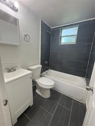 a bathroom with a toilet and a bathtub