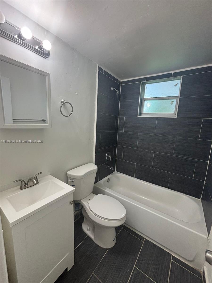 708 Northwest 4th Avenue, Unit 4 Miami, FL 33136 - Photo 17 of 17 a bathroom with a sink a toilet and shower