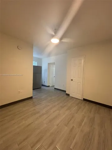 a view of an empty room and wooden floor