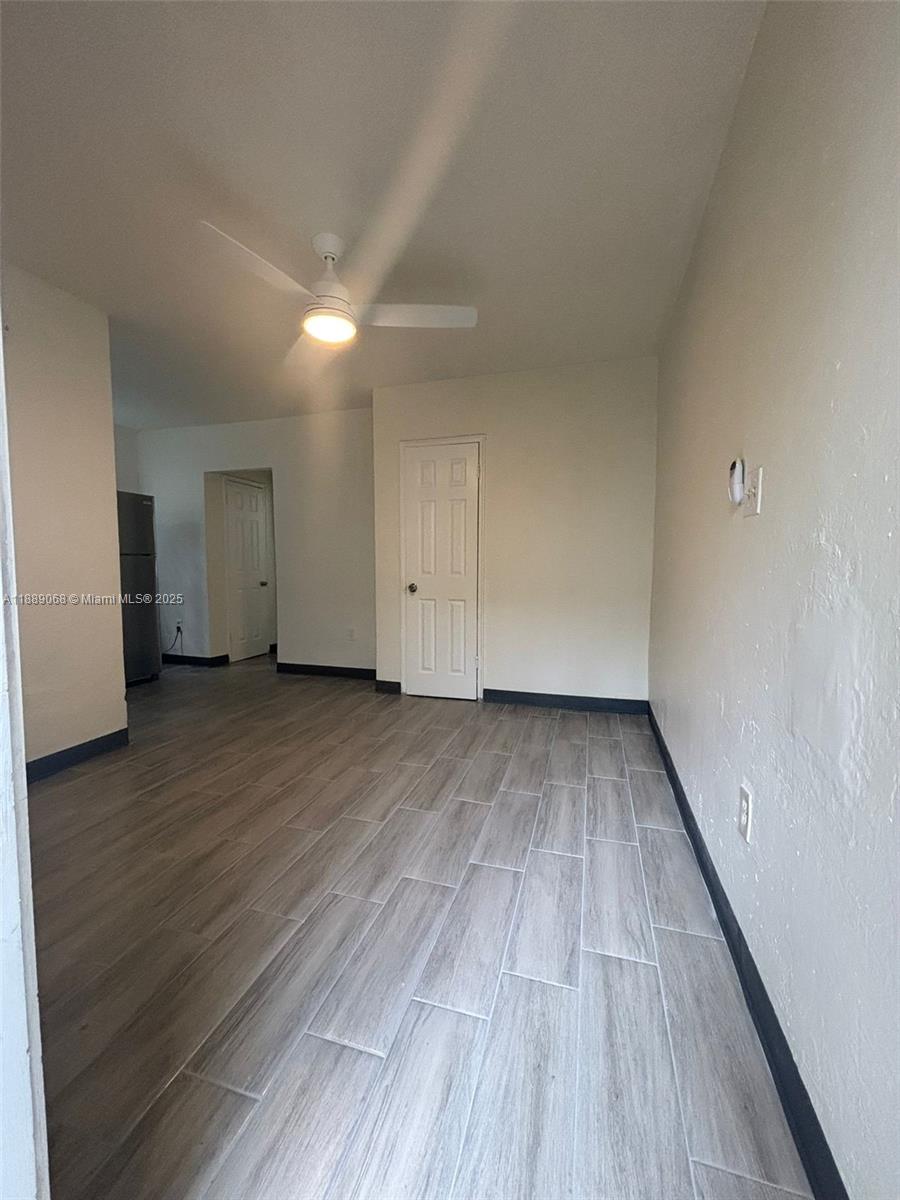 708 Northwest 4th Avenue, Unit 4 Miami, FL 33136 - Photo 4 of 17 a view of an empty room and wooden floor