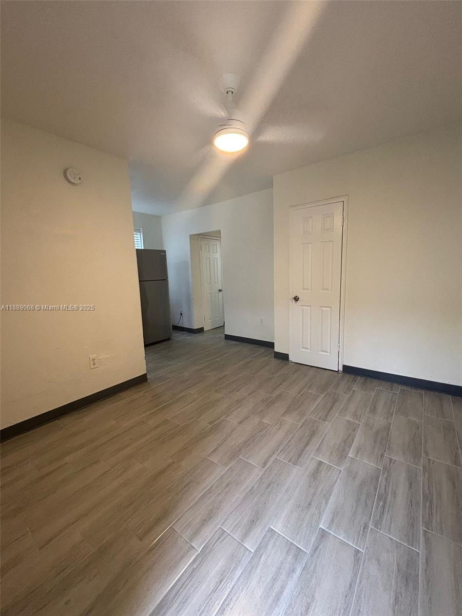 708 Northwest 4th Avenue, Unit 4 Miami, FL 33136 - Photo 5 of 17 a view of an empty room and wooden floor