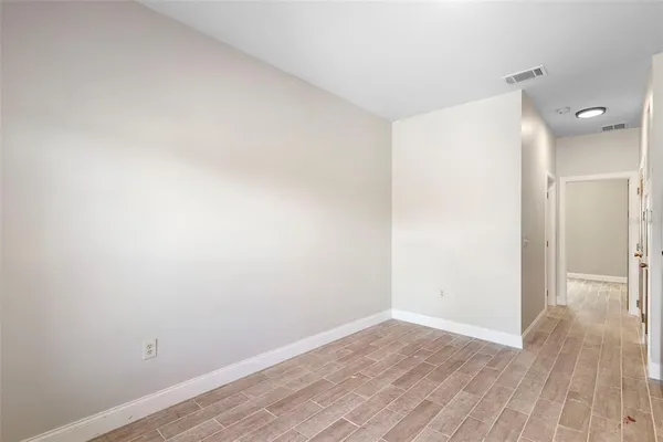 a view of a room with wooden floor