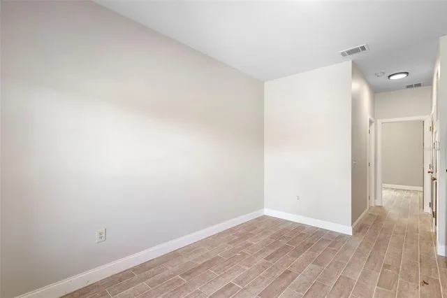 a view of a room with wooden floor