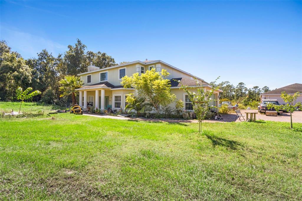 4460 North Fort Christmas Road, Unit 3 Christmas, FL 32820 - Photo 2 of 15 a front view of a house with a yard