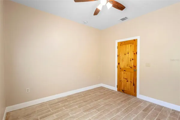 an empty room with a wooden door