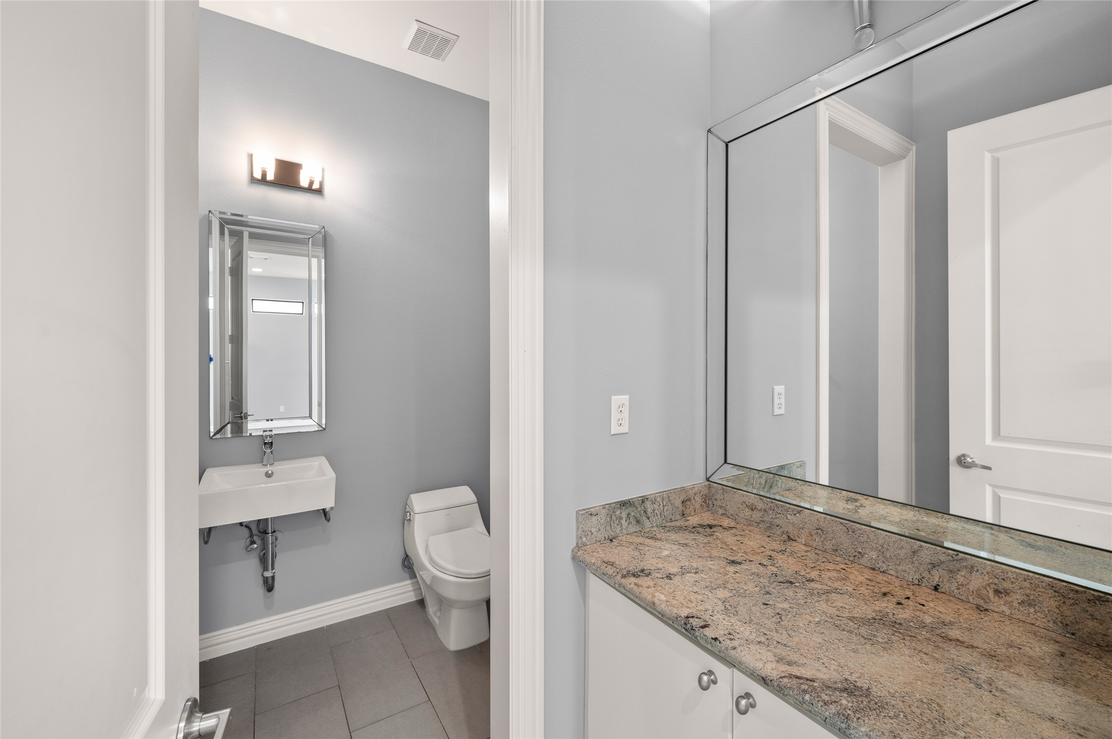 2310 Camden Drive Houston, TX 77021 - Photo 15 of 39 a bathroom with a granite countertop sink toilet and mirror