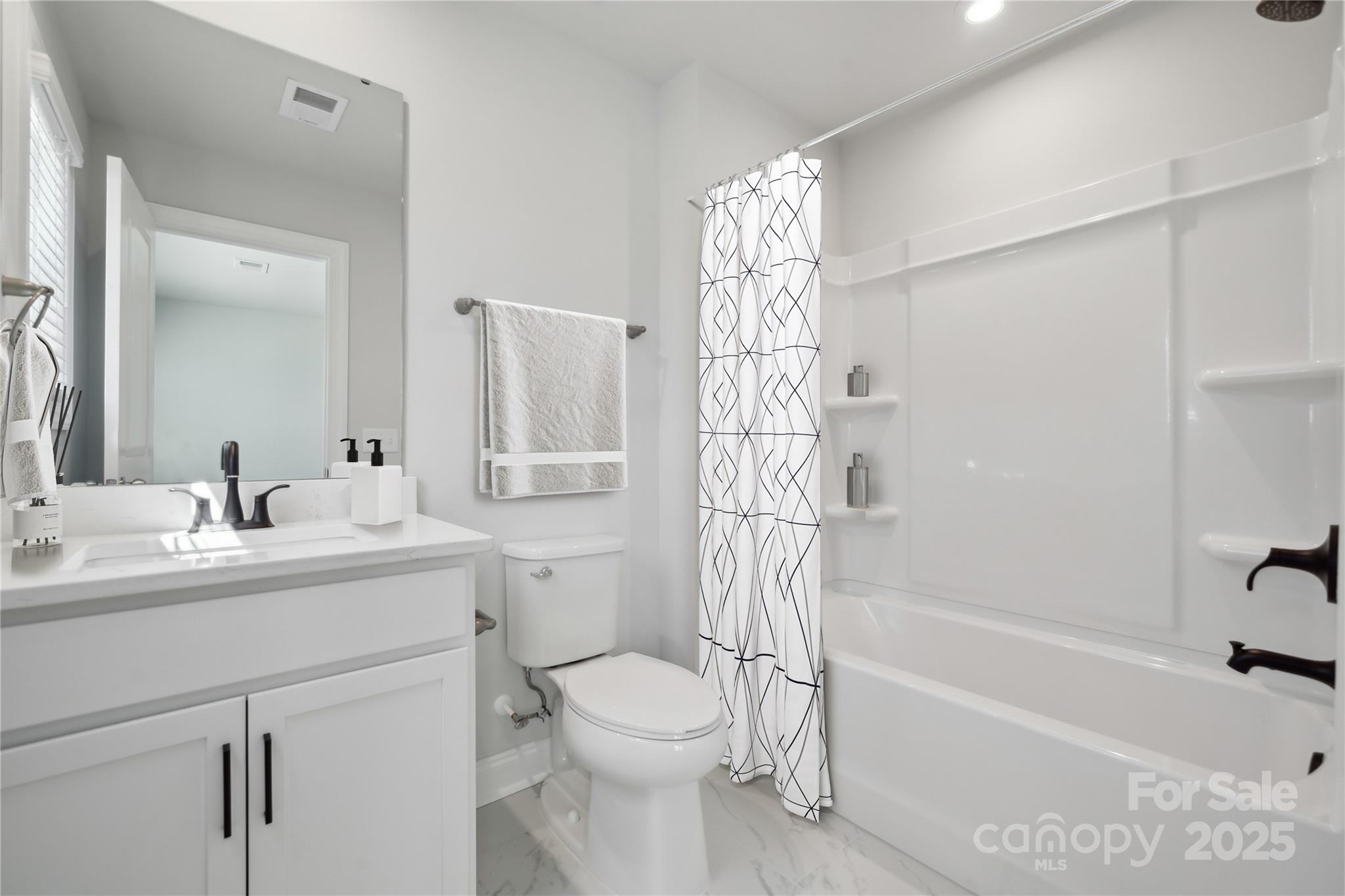 204 Balboa Street Matthews, NC 28104 - Photo 15 of 33 a bathroom with a sink a toilet and shower