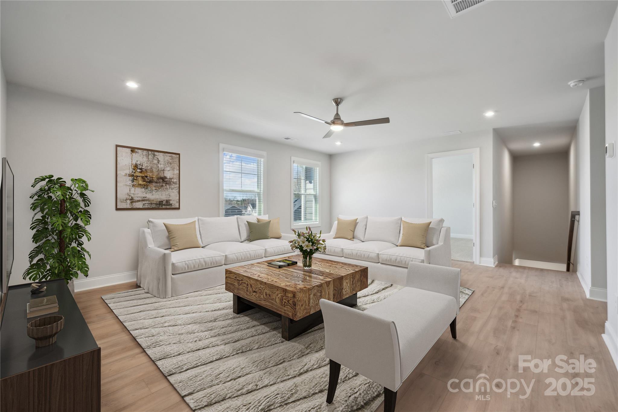 204 Balboa Street Matthews, NC 28104 - Photo 21 of 33 a living room with furniture and a potted plant