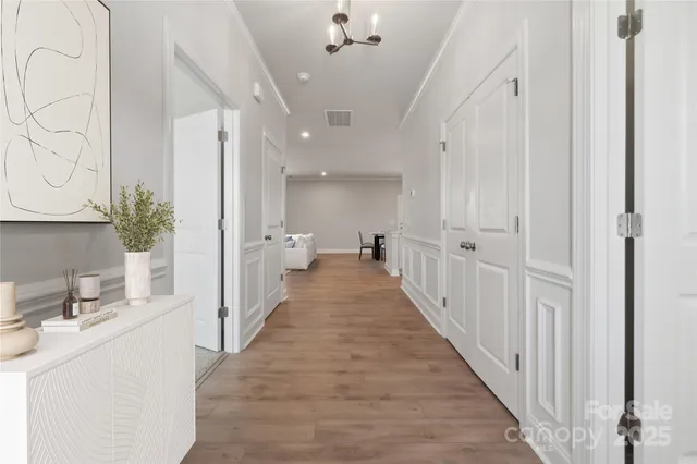 a view of a hallway with a sink and a mirror