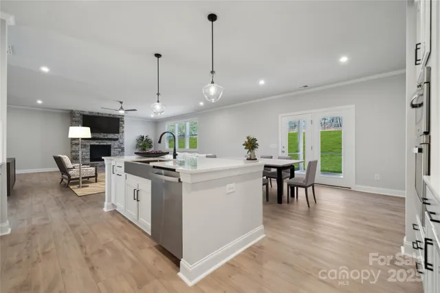 a kitchen that has a lot of cabinets a sink and appliances in it