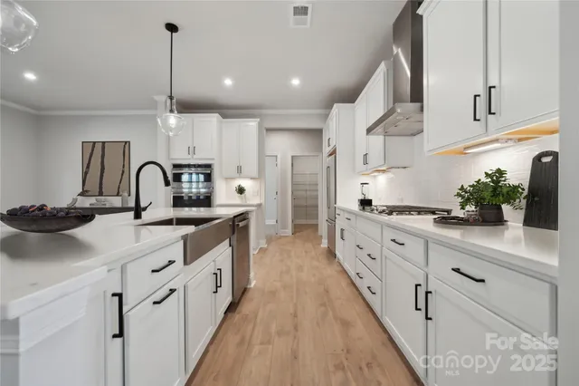 a kitchen with kitchen island granite countertop lots of counter top space and sink