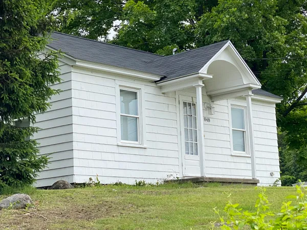 a front view of a house with a yard