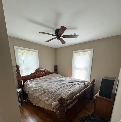 a bedroom with a bed and window