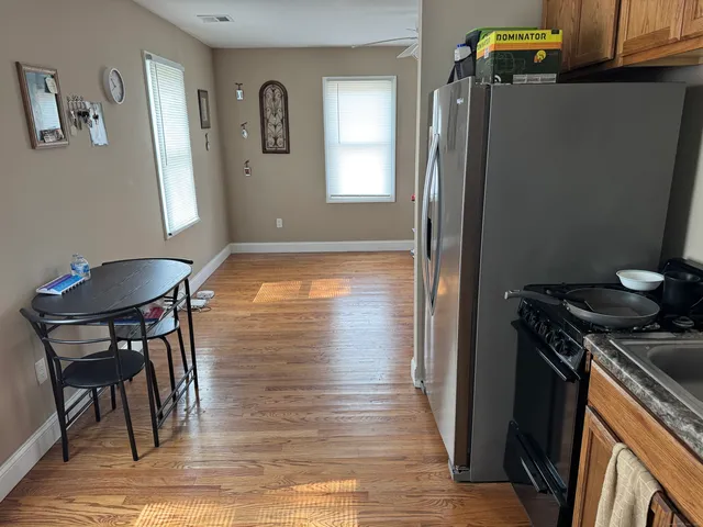 a kitchen with stainless steel appliances granite countertop a refrigerator and a stove top oven
