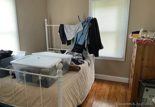 a bedroom with a bed and a flat tv screen on the dresser