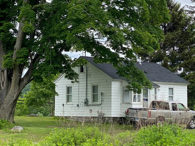 a view of backyard of house with green space