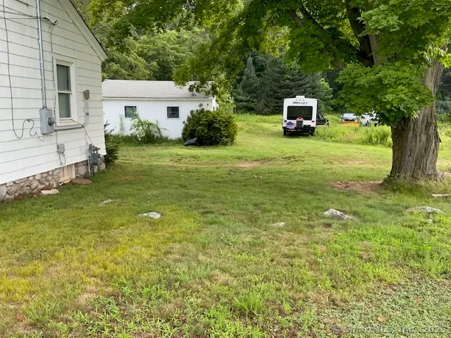 a house view with a sitting space and garden