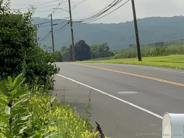 a view of a road with a big yard