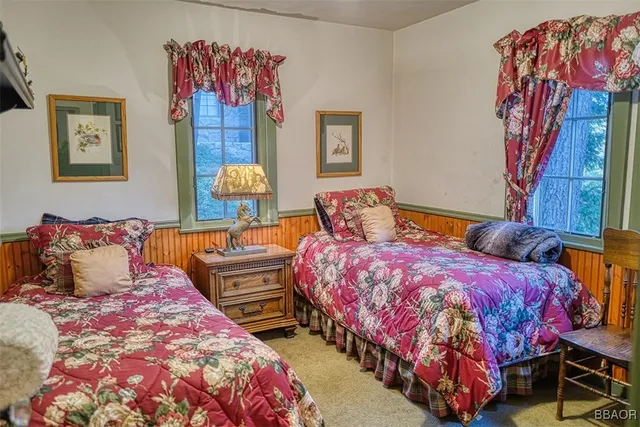 a view of a patio with table and chairs with wooden fence and plants