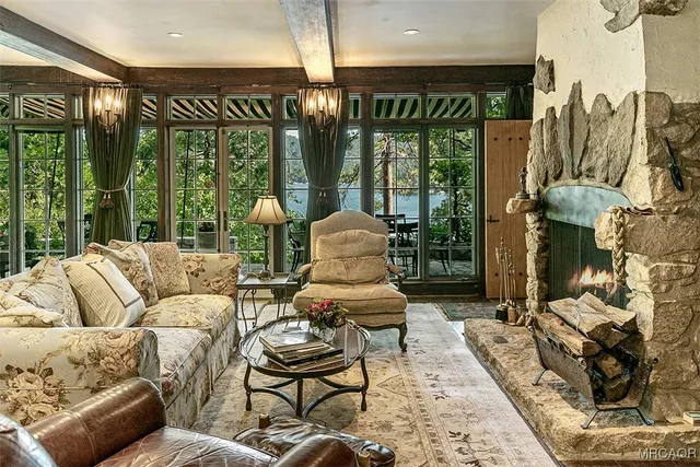 a dining room with furniture and floor to ceiling windows