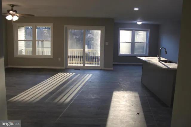 a room with wooden floor and a window