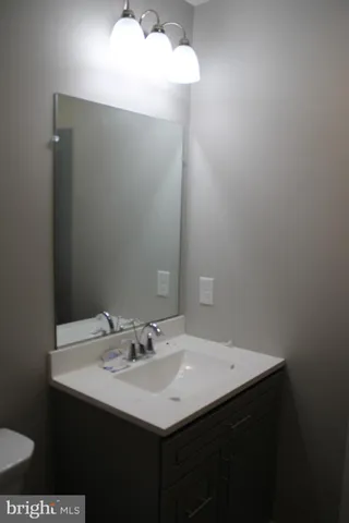 a bathroom with a sink vanity and a mirror