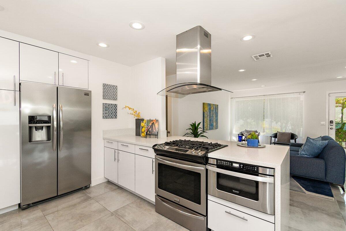 3005 North Chuperosa Road Palm Springs, CA 92262 - Photo 14 of 34 a kitchen with stainless steel appliances a stove a sink and a refrigerator