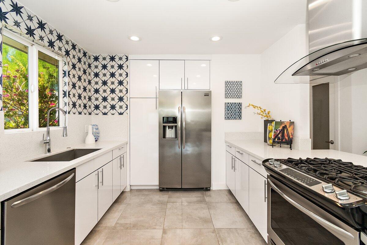 3005 North Chuperosa Road Palm Springs, CA 92262 - Photo 15 of 34 a kitchen with stainless steel appliances granite countertop a sink stove and refrigerator