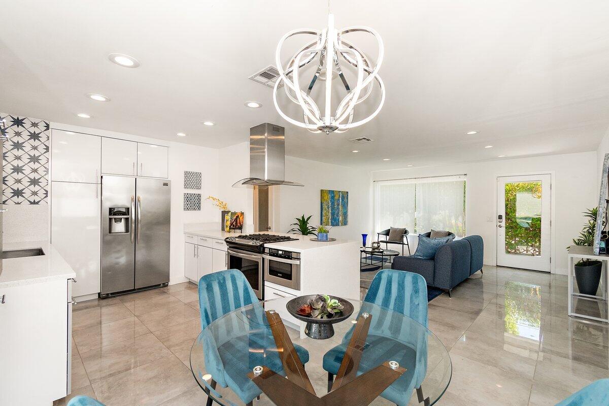 3005 North Chuperosa Road Palm Springs, CA 92262 - Photo 16 of 34 a living room with stainless steel appliances furniture a rug and a chandelier