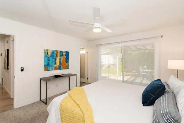 a bedroom with a bed and a large window
