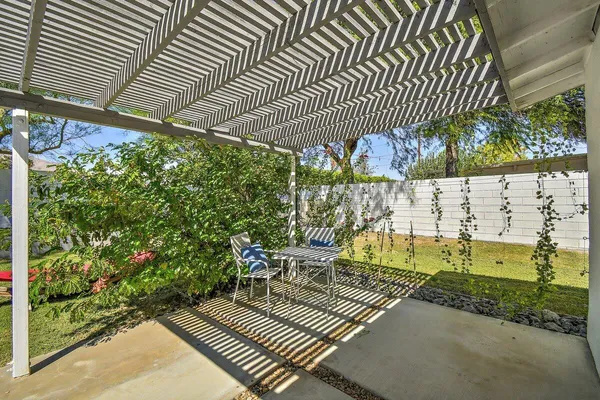 a view of a patio with table and chairs and potted plants